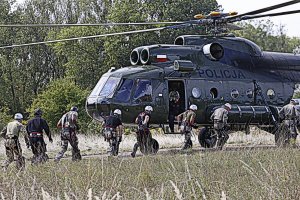 Grupa policjantów biegnie do policyjnego śmigłowca Mi 8 T.