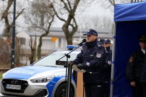 Komendant Wojewódzki Policji w Lublinie przemawia do zgromadzonych gości w tle nowy radiowóz oznakowany.