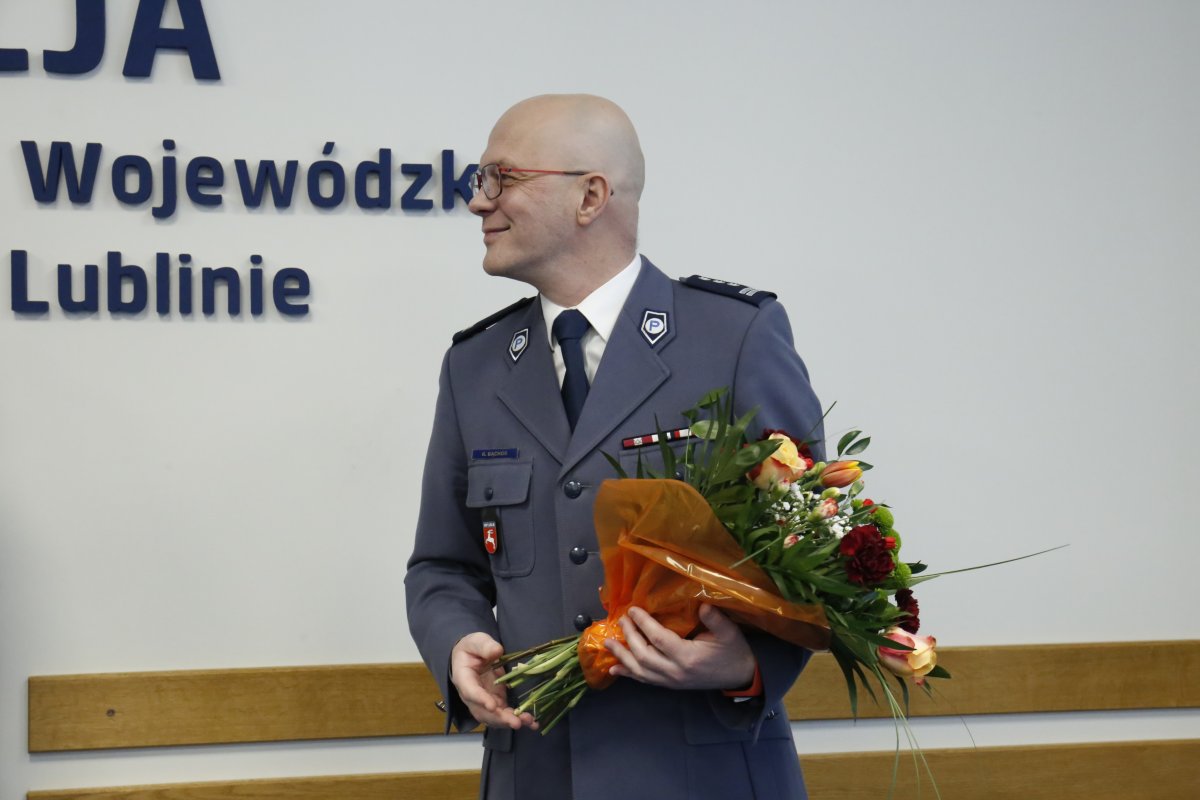 Inspektor Radek Bąchór z kwiatami.