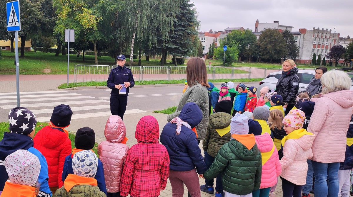 policjantka z dziećmi na przejściu dla pieszych 