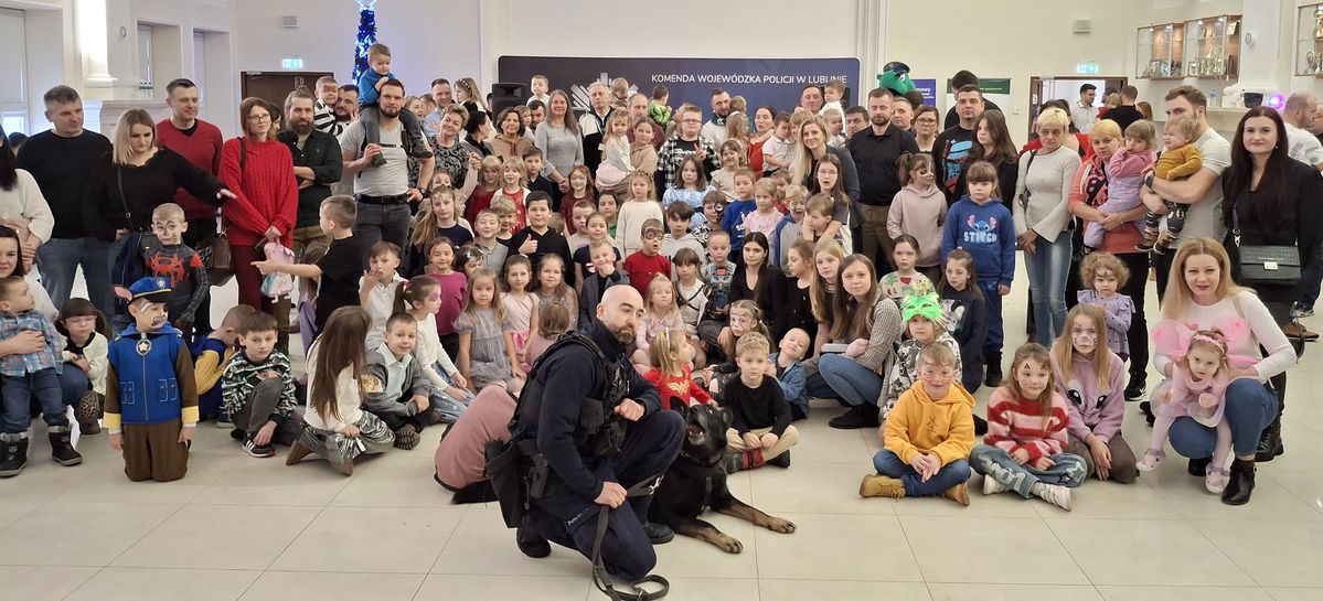 wspólne zdjęcie dzieci z przewodnikiem i psem służbowym