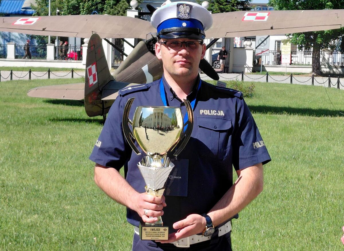 policjant z pucharem za pierwze miejsce 