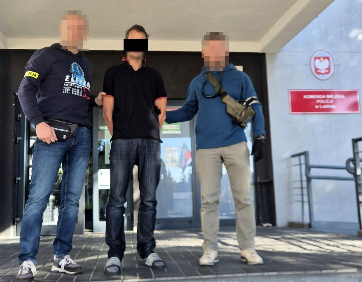 policjanci prowadzą zatrzymanego mężczyznę
