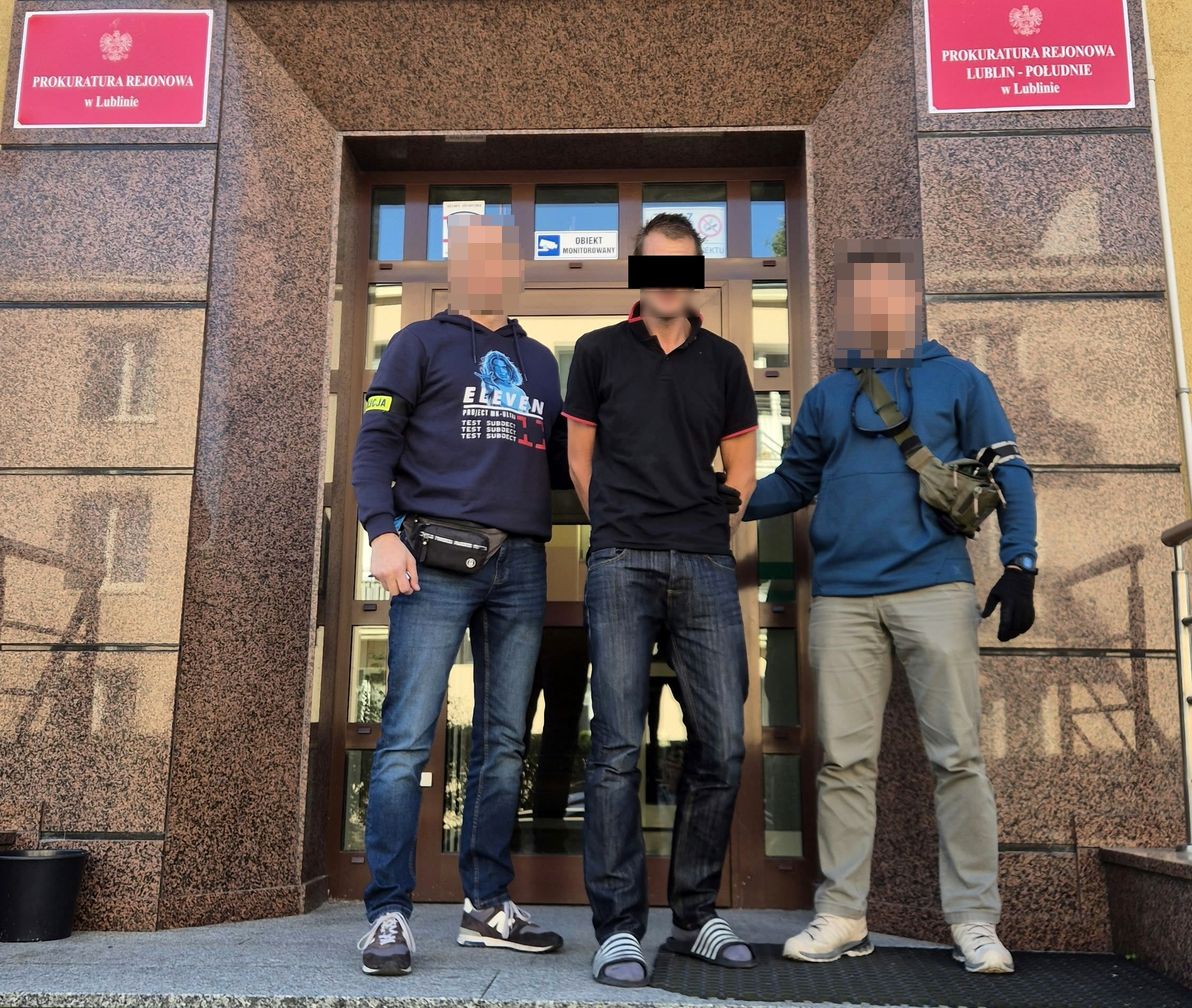 policjanci prowadzą zatrzymanego mężczyznę