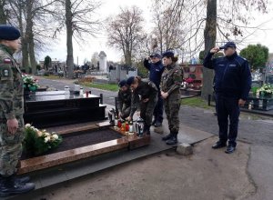 fot. uczniowie Zespołu Szkół w Sobieszynie oraz funkcjonariusze KPP w Rykach składają znicze na nagrobku Wacława Kundzicza.