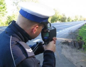 policjant mierzy prędkość pojazdów