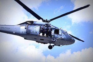 Policyjny Black Hawk w powietrzu na pokładzie funkcjonariusze.