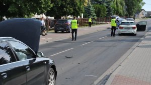samochód marki Hyundai i samochody marki Audi na miejscu wypadku drogowego i pracujący na miejscu wypadku policjanci