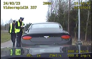 Stop klatka z videorejestratora na którym widać policjantów podczas kontroli pojazdu osobowego.