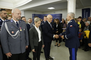 Komendant Wojewódzki Policji w Lublinie nadinspektor Artur Bielecki gratuluje pracownikowi cywilnemu odznaczenia za wieloletnią służbę.
