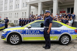 policjanci i pracownicy cywilni przed budynkiem komendy