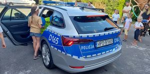 dzieci i policjanci przy radiowozie