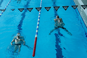 Zdjęcie przedstawia policyjnych wodniaków w czasie ćwiczeń holowania tonącego.