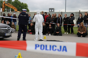 Symulowany wypadek drogowy, gdzie policjanci opowiadają studentom o swoich zadaniach.