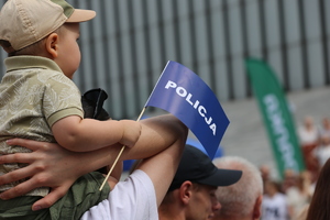 Małe dziecko trzyma w rączce napis policja.