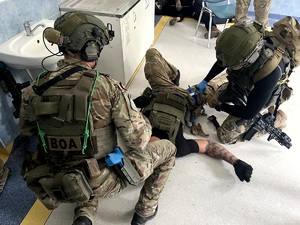 policjanci udzielają pomocy medycznej rannemu