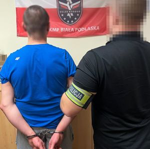 policjant kryminalny z zatrzymanym mężczyzną