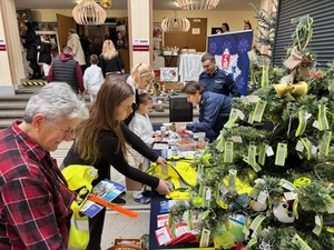 policjanci przy stoisku świątecznym z mieszkańcami