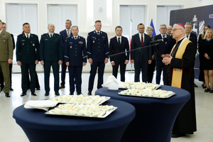 Na pierwszym planie na stole znajdują się pokrojone jajka, które błogosławi Jego Ekscelencja Artur Miziński Biskup Pomocniczy Archidiecezji Lubelskiej. W tle w szeregu stoją Komendanci Komendy Wojewódzkiej Policji w Lublinie