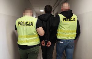 Policjanci prowadzą zatrzymanego mężczyznę
