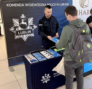 policjant prezentuje stoisko promocyjne podczas Dnia Kariery w Uniwersytecie Przyrodniczym w Lublinie