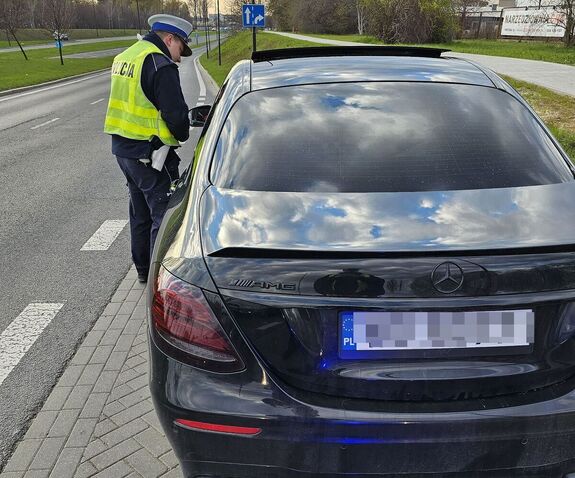 policjant kontroluje prędkość kierującego pojazdem osobowym