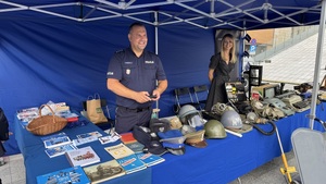 Policjant prezentuje wyposażenie jaki kiedyś służył w policji.